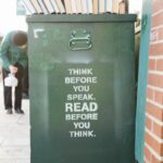 books over green trolley bin