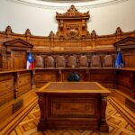 a courtroom with a large wooden bench