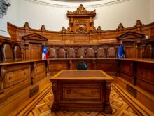 a courtroom with a large wooden bench